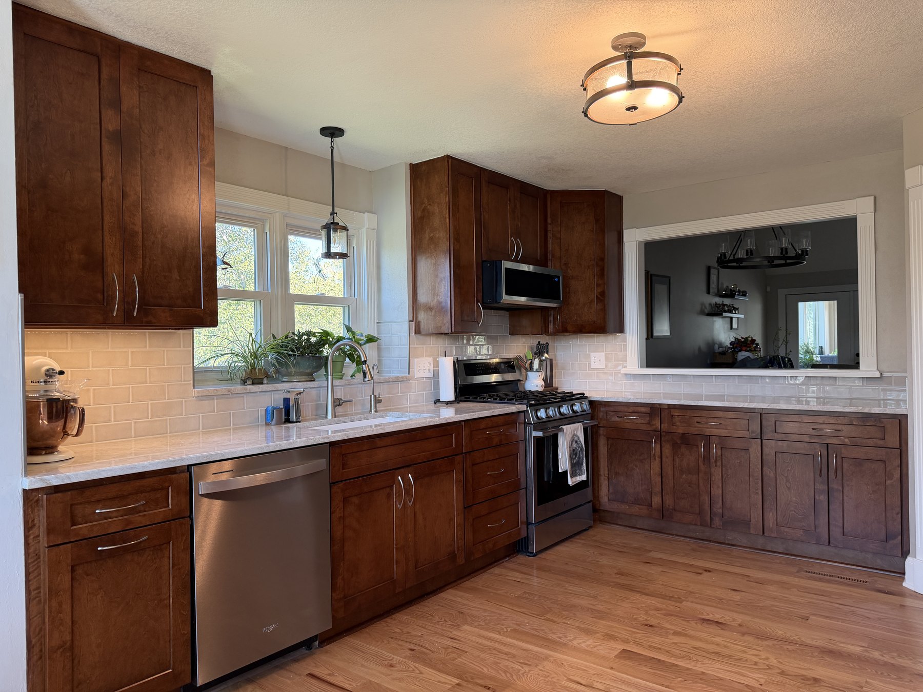 Liberty, MO kitchen remodel with custom stained shaker cabinets, quartzite counters and hardwood floors