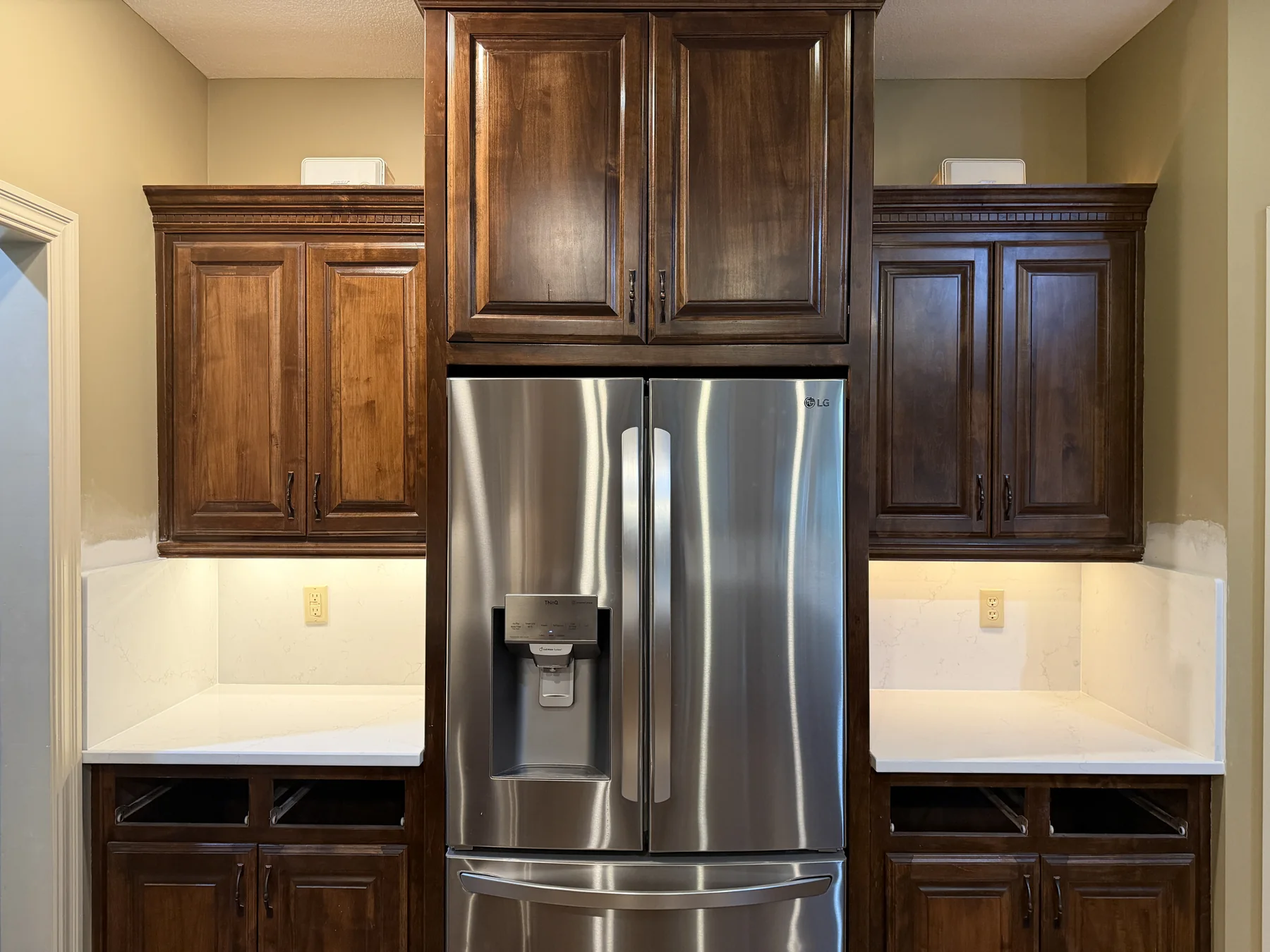 Quartz countertop island with gray cabinets installed by KC Cabinetry & Stone