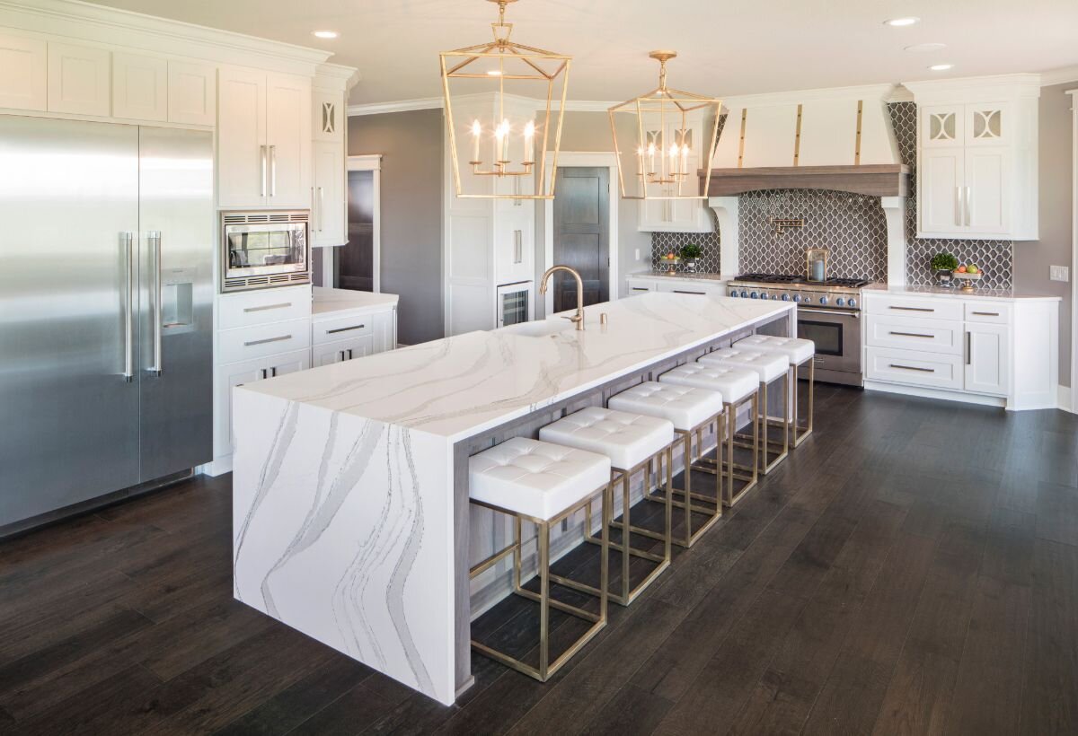 White quartz countertops and waterfall island installed in a Kansas City kitchen