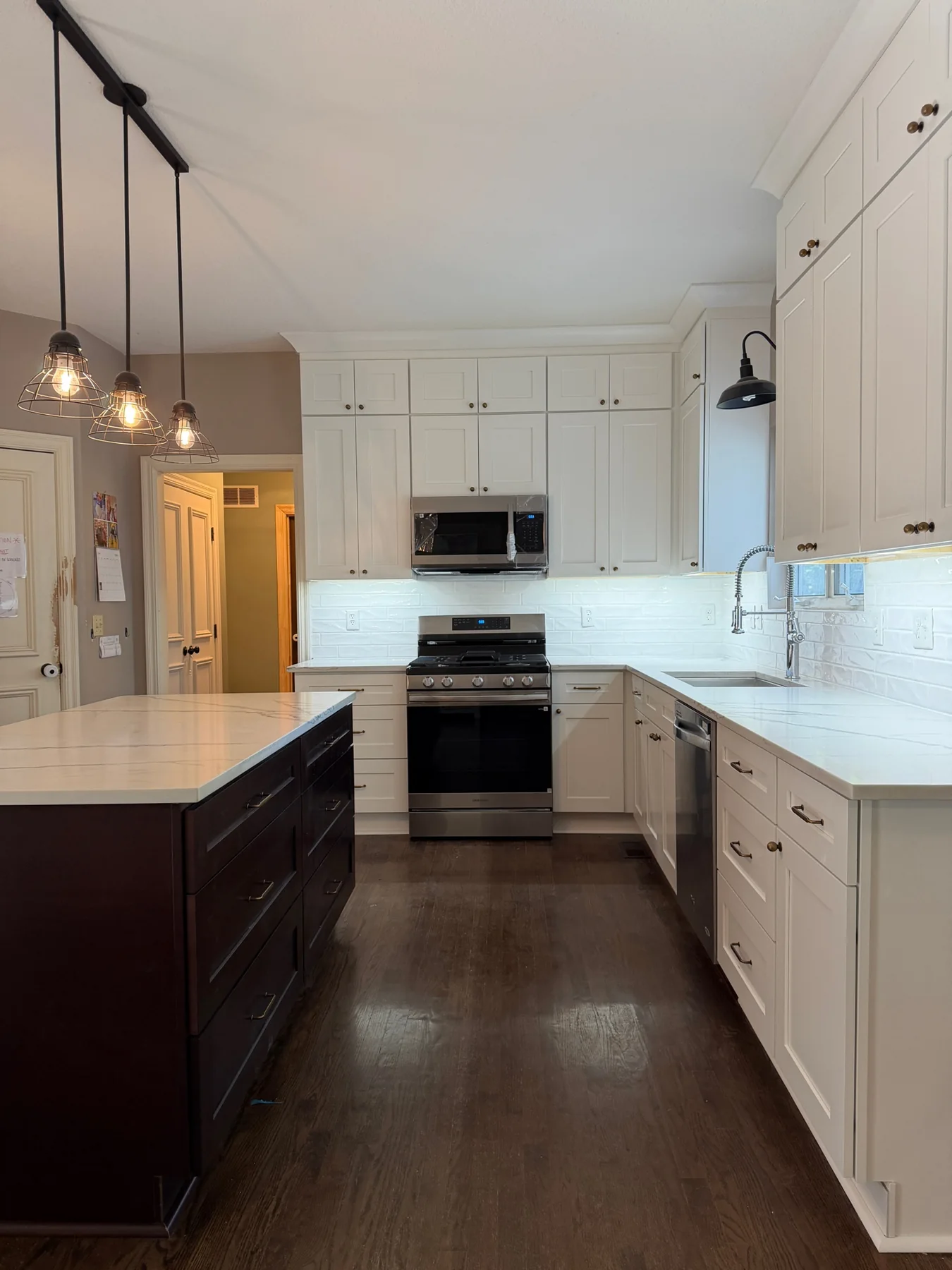 White quartz countertops with gold cabinet hardware installed by KC Cabinetry & Stone